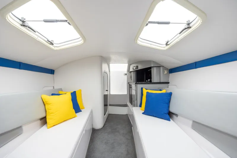 Slide: The Image of Interior of 2014 Baja 35 Outlaw boat with colorful cushions and modern design. - 26