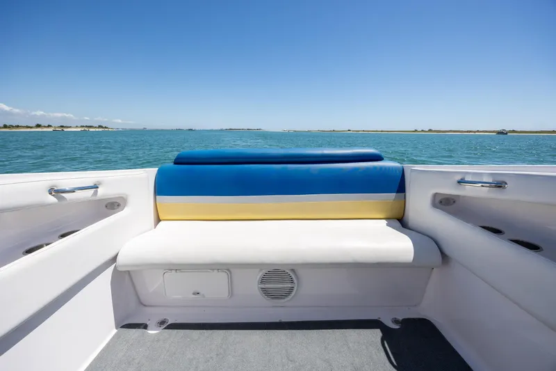 Slide: The Image of 2014 Baja 35 Outlaw boat interior with blue and yellow seating, ocean view. - 27