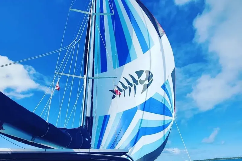 Slide: The Image of Sailboat with colorful spinnaker featuring fish design, C&C 37/40 XL, 1993 model. - 2