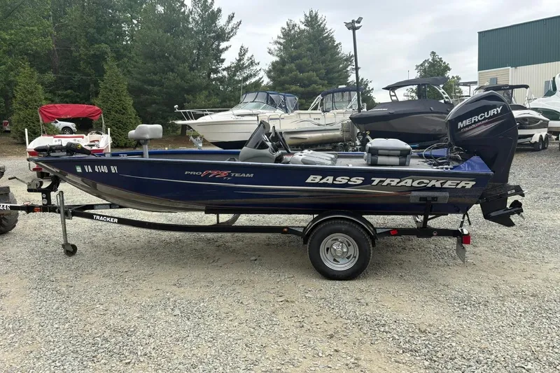 The Image of 2015 Tracker Pro Team 175 TF bass boat on trailer, parked outdoors. - 0