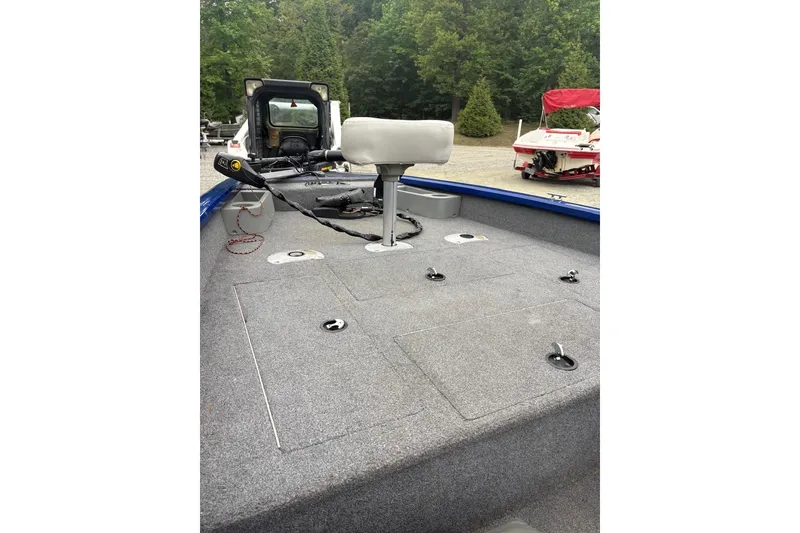 Slide: The Image of 2015 Tracker Pro Team 175 TF boat interior with fishing seat and storage compartments. - 10