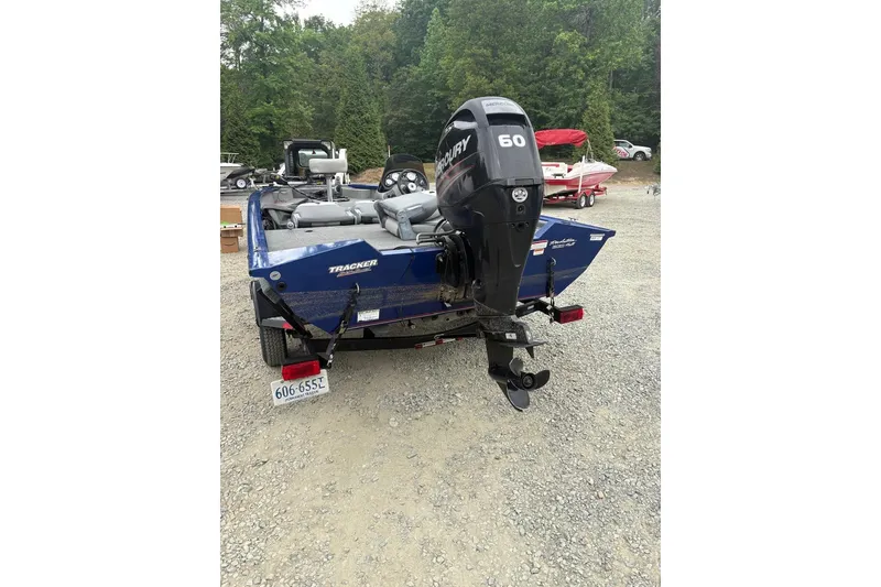 Slide: The Image of 2015 Tracker Pro Team 175 TF boat with Mercury 60 engine, parked on gravel. - 2
