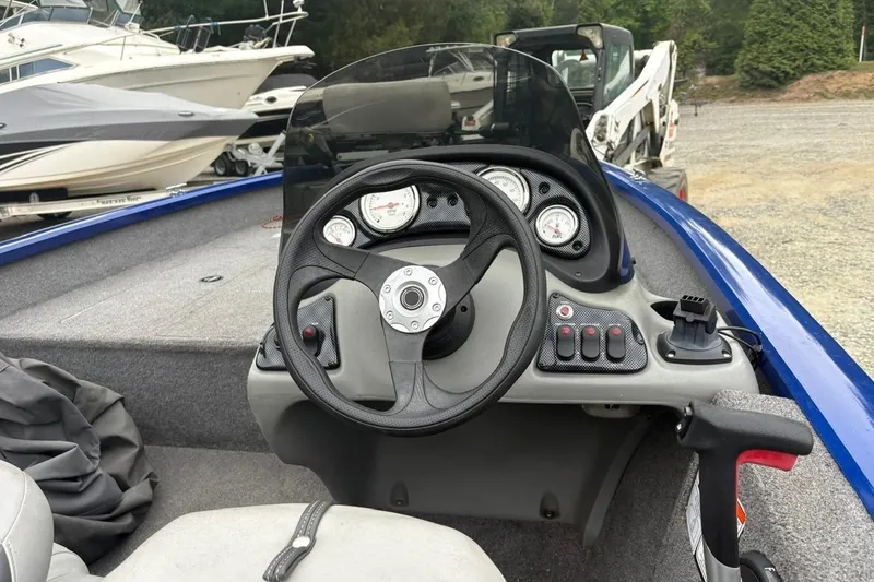 Slide: The Image of Steering console of a 2015 Tracker Pro Team 175 TF boat, featuring gauges and controls. - 5