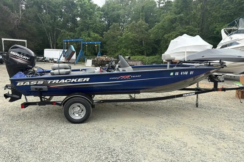 Slide: The Image of 2015 Tracker Pro Team 175 TF bass boat on trailer, parked outdoors. - 6