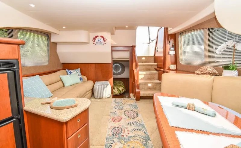 Slide: The Image of Interior of 2007 Silverton 35 Motor Yacht with cozy seating and elegant decor. - 14