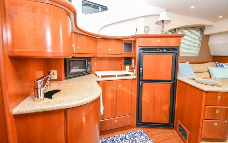 Slide: The Image of 2007 Silverton 35 Motor Yacht interior with wood cabinetry and modern kitchen amenities. - 15