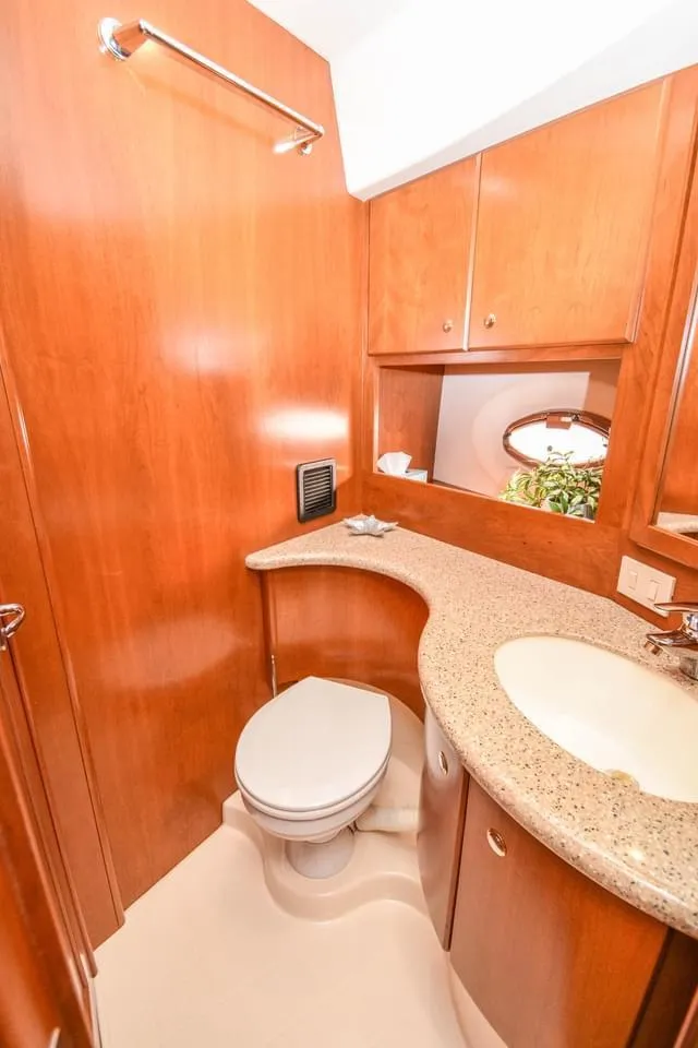 Slide: The Image of 2007 Silverton 35 Motor Yacht bathroom with wood cabinetry and modern fixtures. - 9