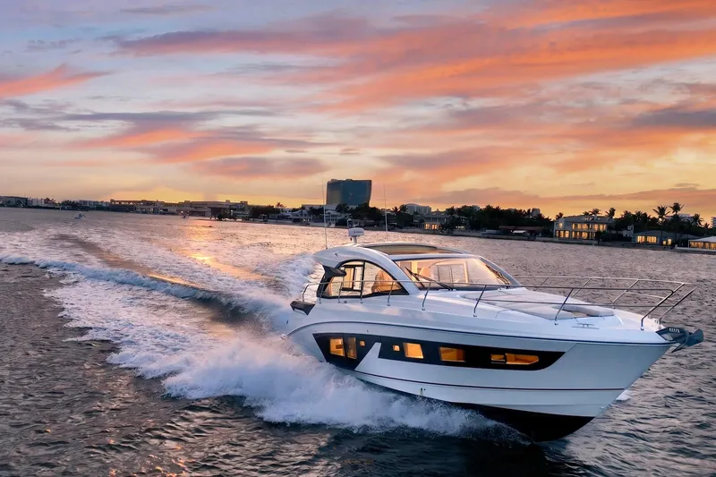 The Image of 2023 Beneteau Gran Turismo 45 yacht cruising at sunset on open water. - 1