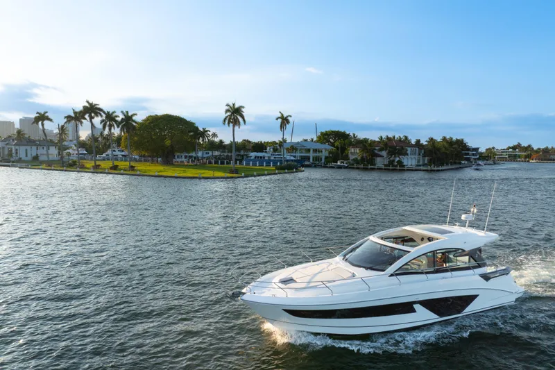 Slide: The Image of 2023 Beneteau Gran Turismo 45 yacht cruising near a tropical island with palm trees. - 11