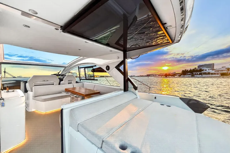 Slide: The Image of 2023 Beneteau Gran Turismo 45 yacht interior with sunset view over the water. - 16