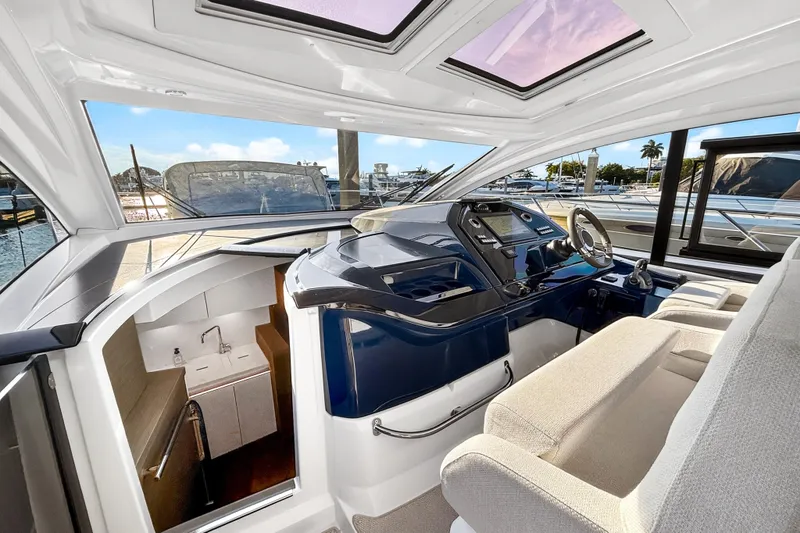 Slide: The Image of Interior view of 2023 Beneteau Gran Turismo 45 yacht, featuring helm and seating area. - 17