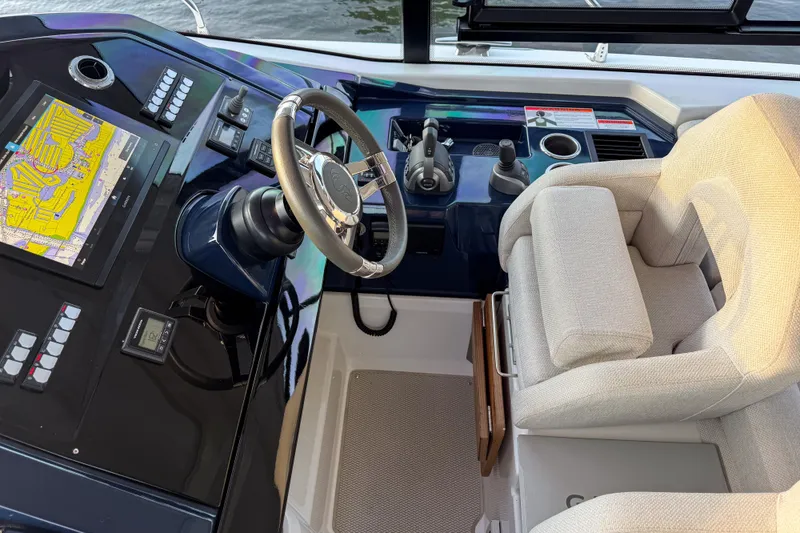 Slide: The Image of 2023 Beneteau Gran Turismo 45 helm with navigation display and plush captain's chair. - 19