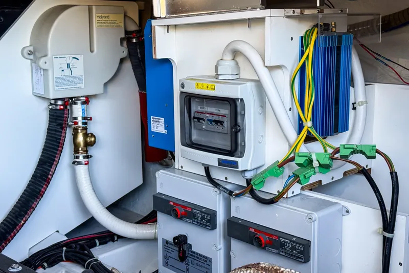 Slide: The Image of Engine room of 2023 Beneteau Gran Turismo 45 with electrical components and wiring. - 24