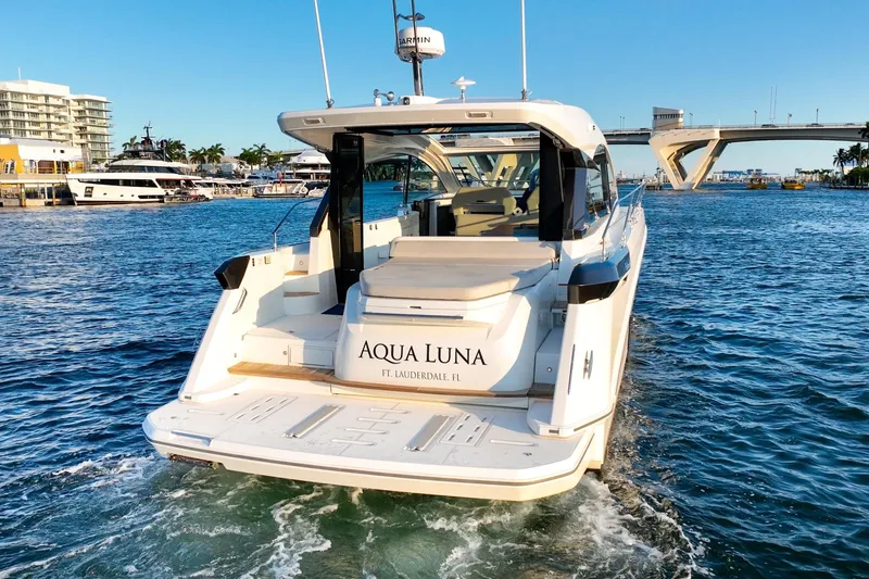 Slide: The Image of 2023 Beneteau Gran Turismo 45 yacht cruising in sunny waters near a bridge. - 3