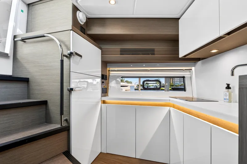 Slide: The Image of Modern kitchen interior of 2023 Beneteau Gran Turismo 45 yacht with sleek cabinetry and window view. - 35