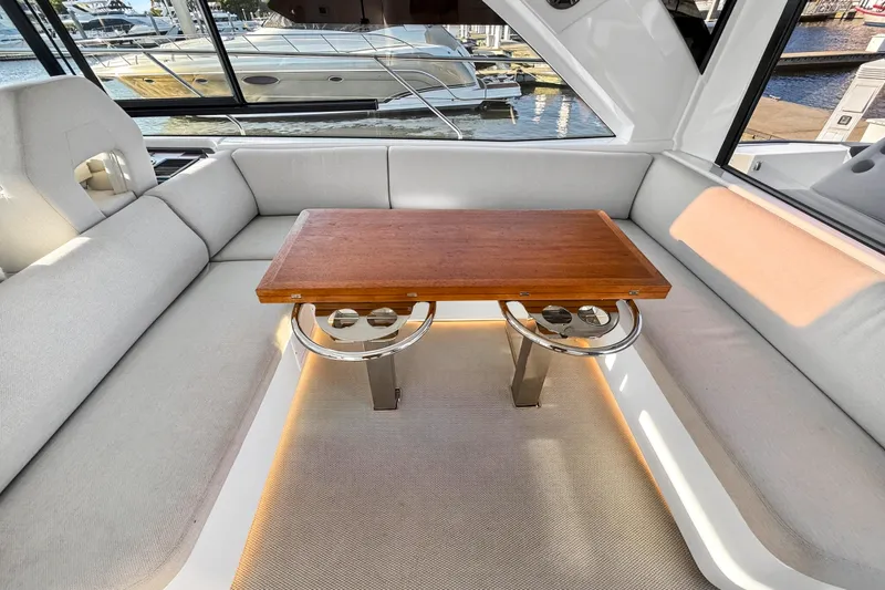 Slide: The Image of Luxurious interior of 2023 Beneteau Gran Turismo 45 yacht with elegant seating and wooden table. - 38