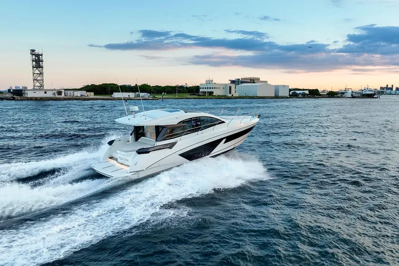 Slide: The Image of 2023 Beneteau Gran Turismo 45 yacht cruising on open water at sunset. - 4