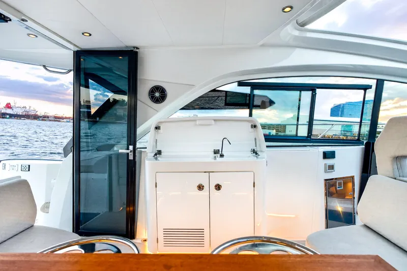 Slide: The Image of Interior view of 2023 Beneteau Gran Turismo 45 yacht with modern amenities and waterfront backdrop. - 41