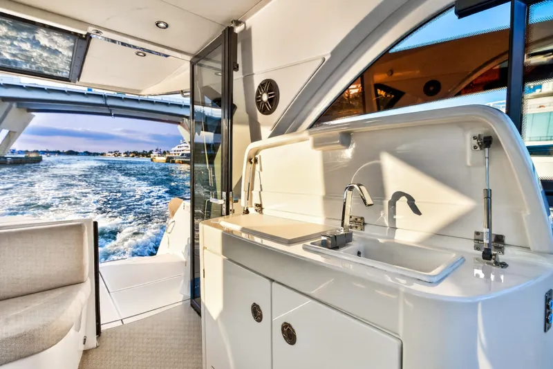 Slide: The Image of 2023 Beneteau Gran Turismo 45 yacht interior with kitchenette and ocean view. - 43
