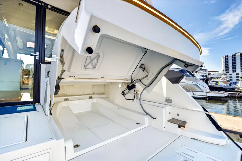 Slide: The Image of 2023 Beneteau Gran Turismo 45 yacht with open storage compartment at marina. - 47