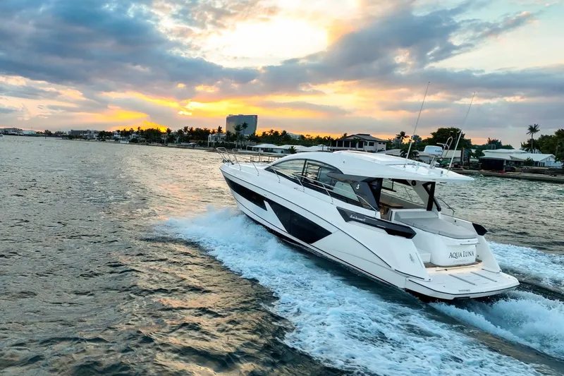 Slide: The Image of 2023 Beneteau Gran Turismo 45 yacht cruising at sunset on open water. - 5
