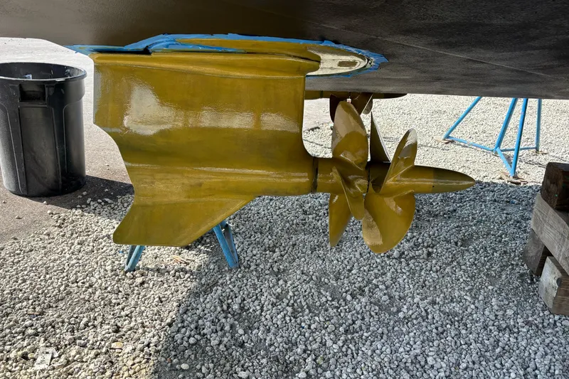 Slide: The Image of Close-up of 2023 Beneteau Gran Turismo 45 propeller and rudder on gravel surface. - 54