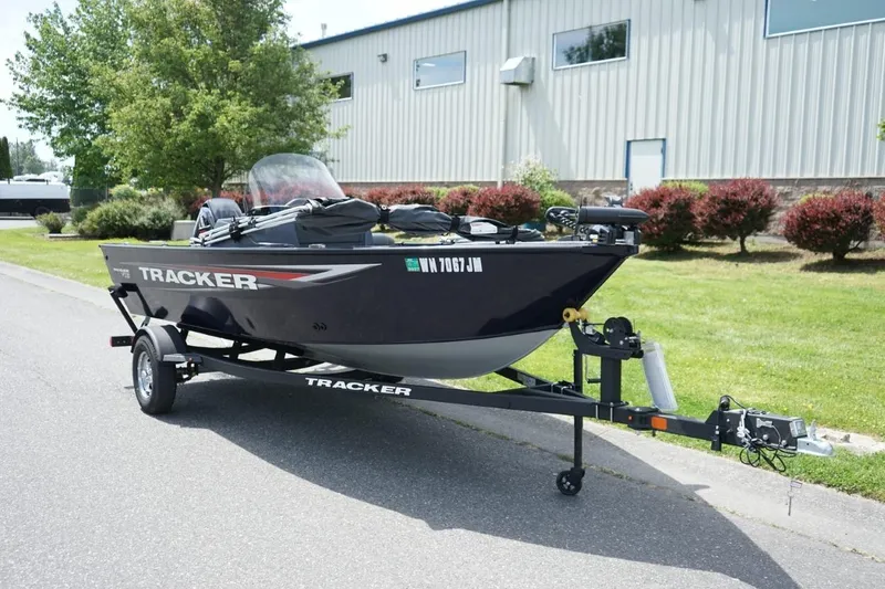 The Image of 2025 TRACKER BOATS Pro Guide V16 SC on trailer, parked outdoors. - 1