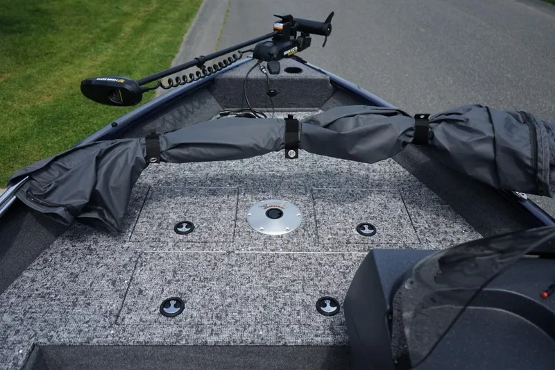 Slide: The Image of 2025 TRACKER BOATS Pro Guide V16 SC interior with fishing rod storage and trolling motor. - 10