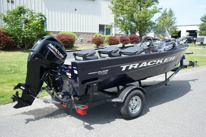 Slide: The Image of 2025 TRACKER BOATS Pro Guide V16 SC on trailer, parked outdoors. - 3