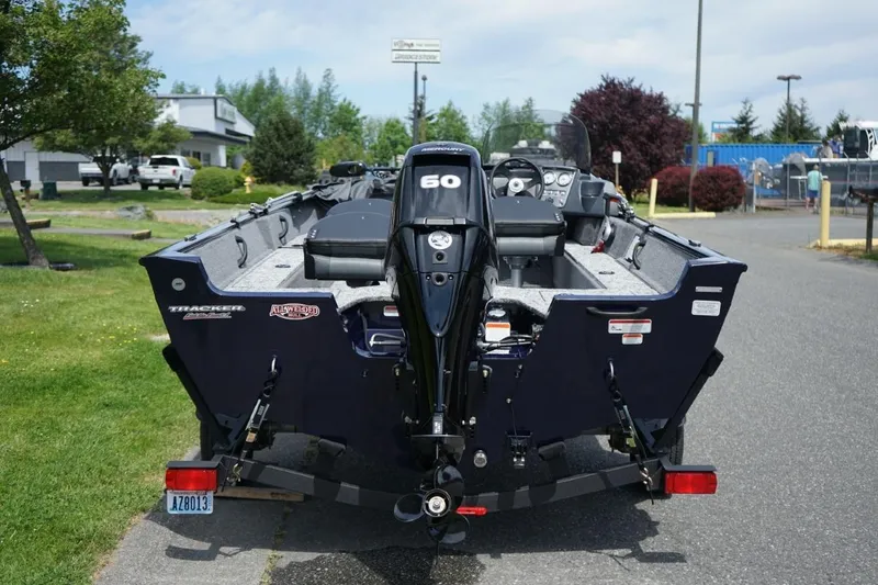 Slide: The Image of 2025 TRACKER BOATS Pro Guide V16 SC with 60 HP engine, parked outdoors. - 4
