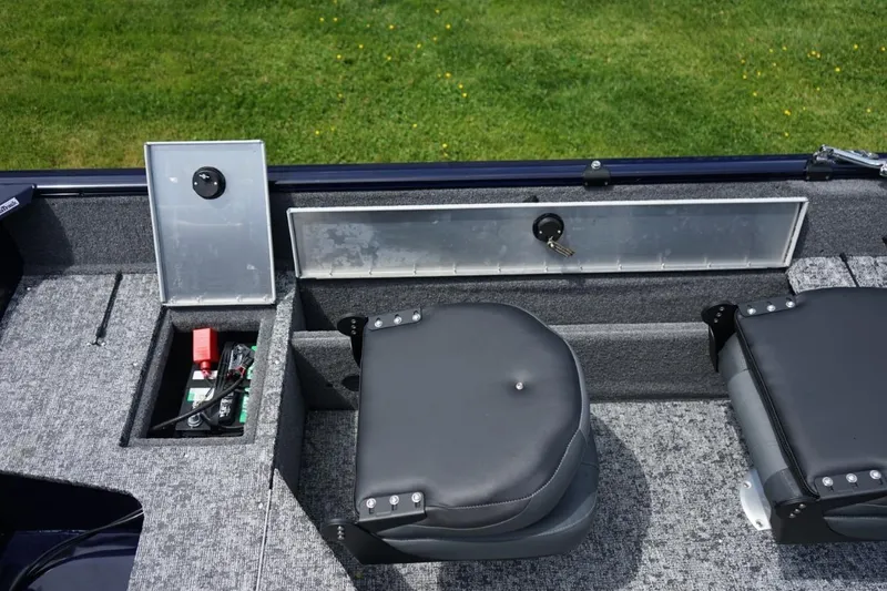 Slide: The Image of 2025 TRACKER BOATS Pro Guide V16 SC interior with storage compartments and seating. - 8