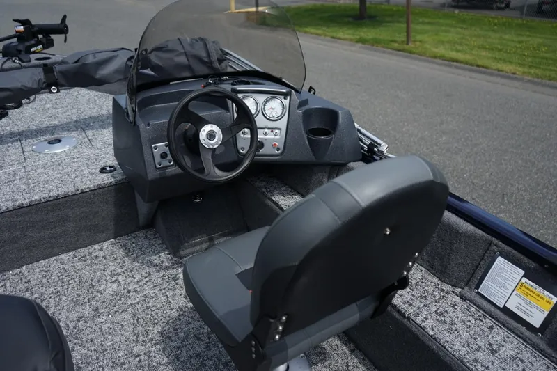 Slide: The Image of 2025 TRACKER BOATS Pro Guide V16 SC interior with steering wheel and seating. - 9