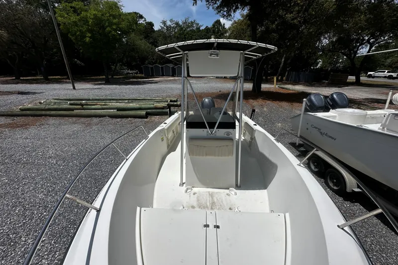 Slide: The Image of 2008 Hydra Sport 212 Lightning boat with T-top, parked on gravel lot. - 6