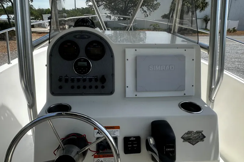 Slide: The Image of 2008 Hydra Sport 212 Lightning boat dashboard with steering wheel and Simrad navigation system. - 8
