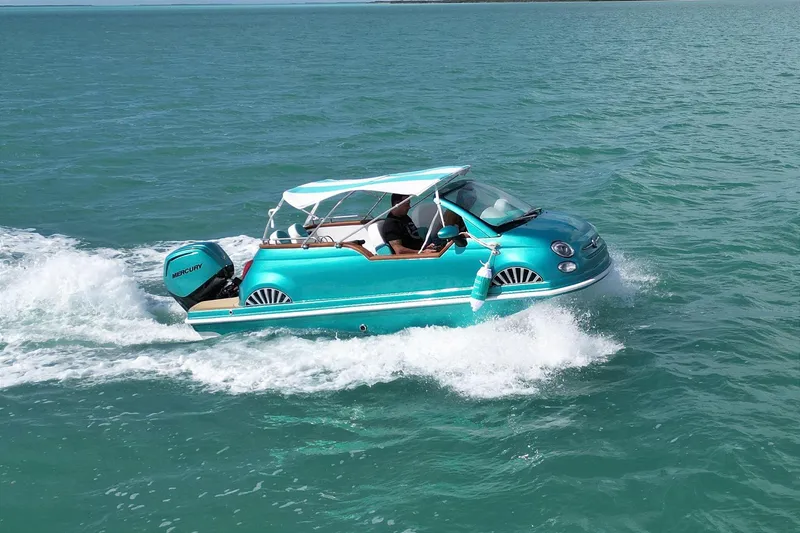 The Image of Amphibious vehicle resembling a Fiat 500 Classic navigating turquoise waters under a clear sky. - 0