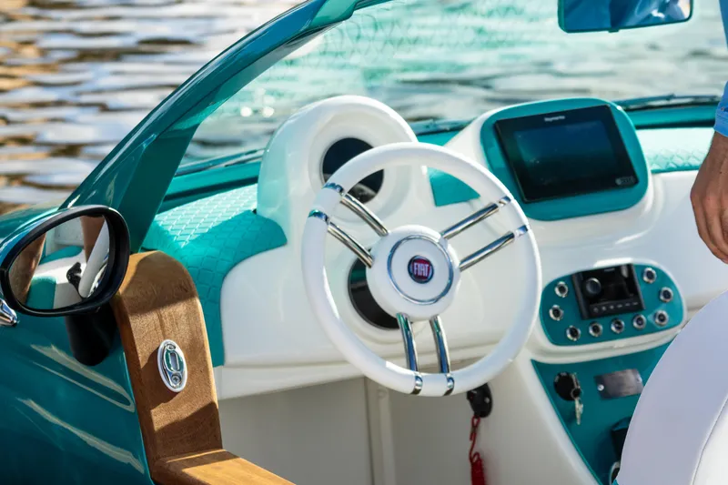 Slide: The Image of Interior of a 2025 Car Off-shore Fiat 500 Classic boat with modern dashboard and steering wheel. - 16