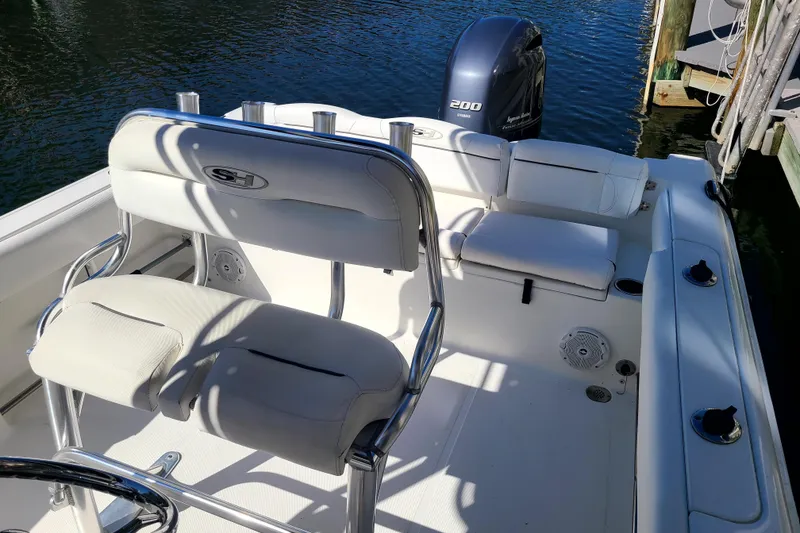 Slide: The Image of 2017 Sea Hunt Ultra 225 boat interior with seating and Yamaha engine. - 12