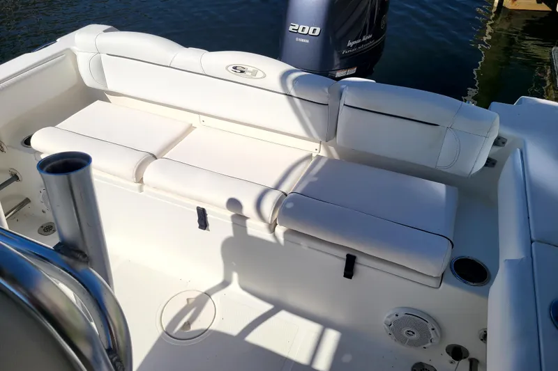 Slide: The Image of 2017 Sea Hunt Ultra 225 boat interior with white seating and Yamaha 200 engine. - 13
