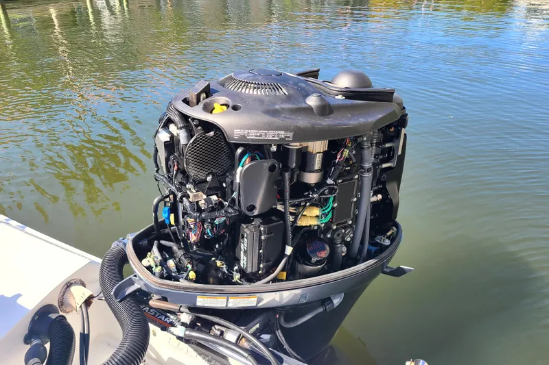 Slide: The Image of Open outboard motor of a 2017 Sea Hunt Ultra 225 boat on water. - 17