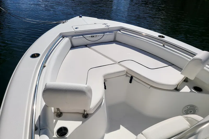 Slide: The Image of 2017 Sea Hunt Ultra 225 boat interior with cushioned seating and stainless steel railings. - 4