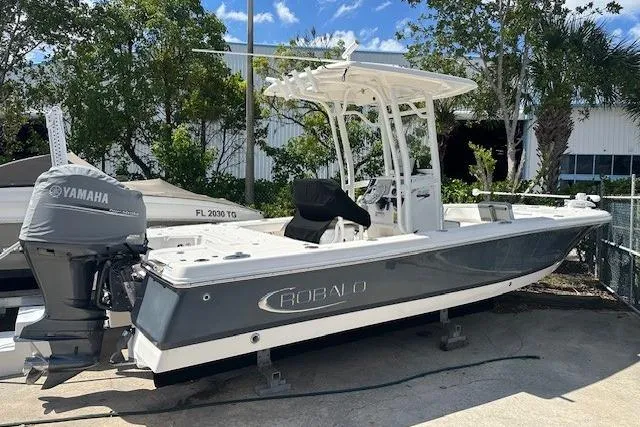 The Image of 2020 Robalo 246 Cayman boat with Yamaha engine, parked outdoors under a clear sky. - 1