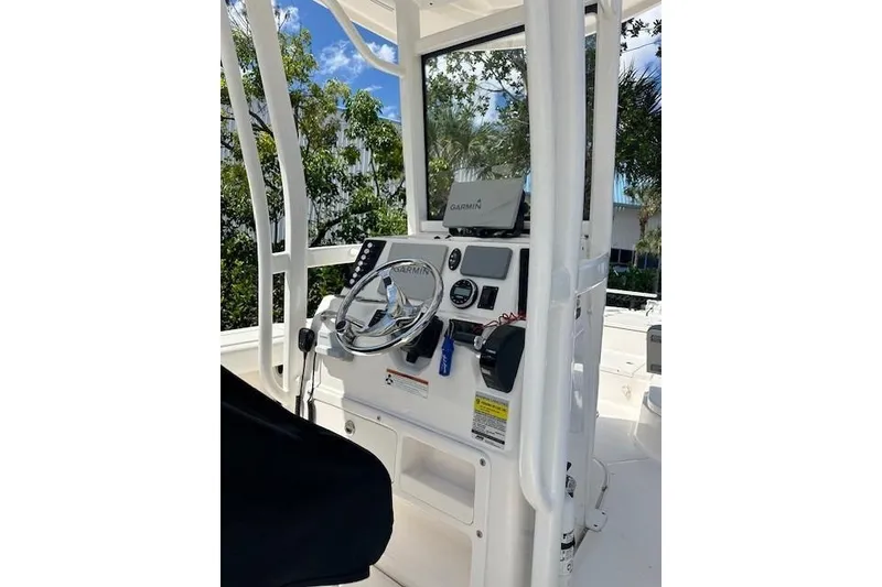 Slide: The Image of 2020 Robalo 246 Cayman boat console with Garmin navigation system and steering wheel. - 3