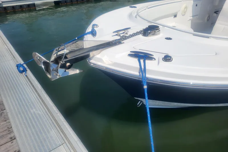 Slide: The Image of Edgewater 245CC 2022 boat docked, featuring anchor and blue mooring lines. - 20
