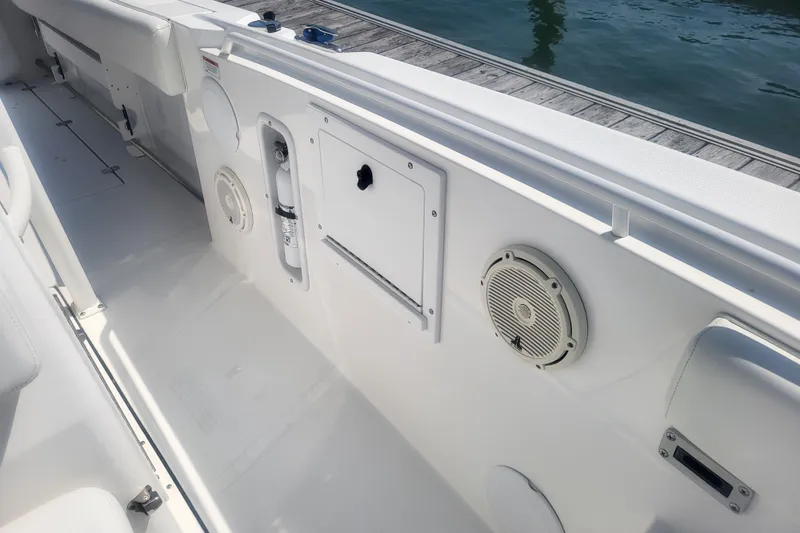 Slide: The Image of Interior view of 2022 Edgewater 245CC boat, featuring speakers and storage compartments. - 22