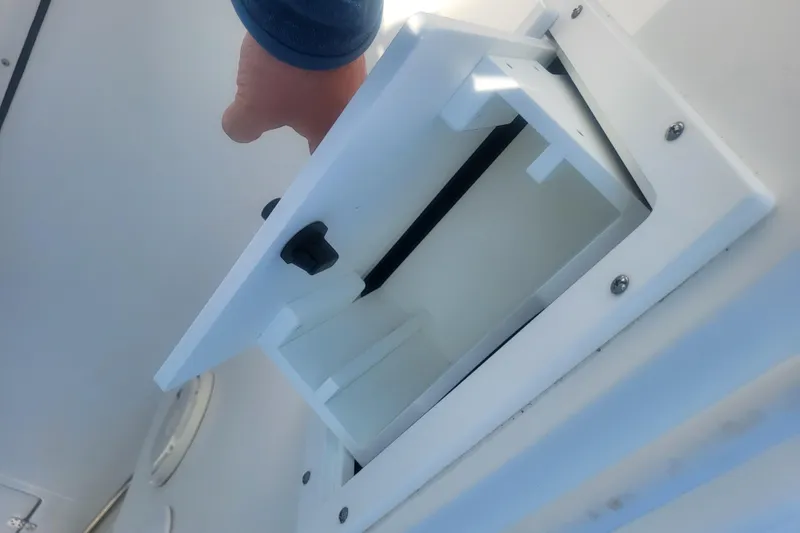 Slide: The Image of Open storage compartment on 2022 Edgewater 245CC boat, showcasing interior space. - 23