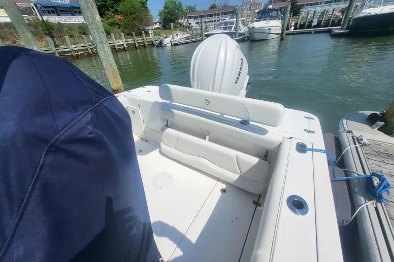 Slide: The Image of 2022 Edgewater 245CC boat docked, featuring Yamaha outboard motor. - 24