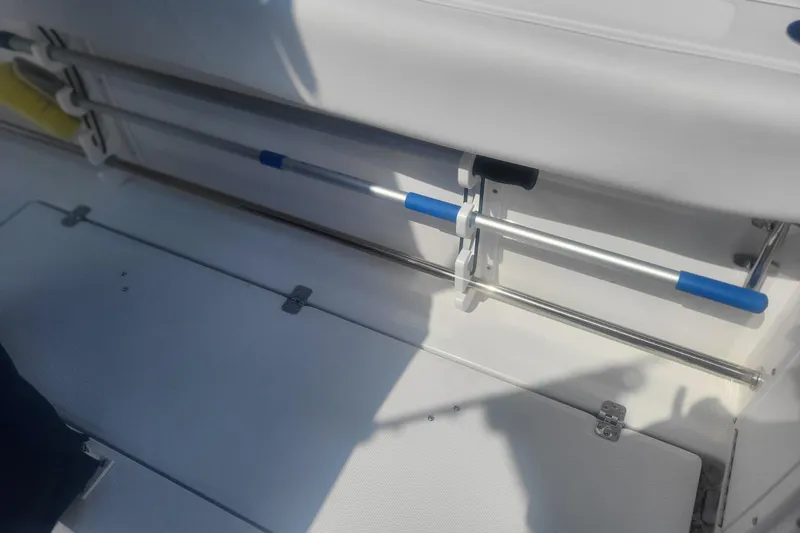 Slide: The Image of 2022 Edgewater 245CC boat interior with storage compartment and mounted equipment. - 25