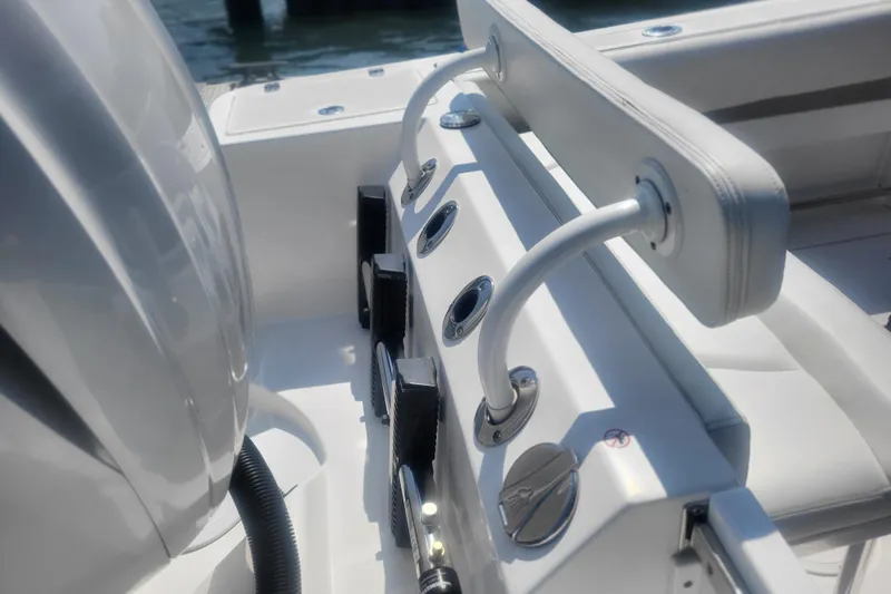 Slide: The Image of Edgewater 245CC 2022 boat interior with rod holders and seating. - 29