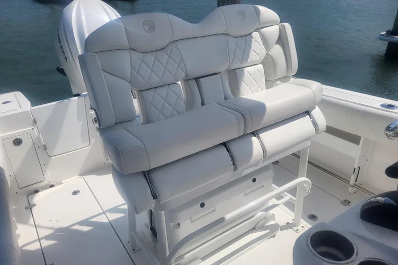 Slide: The Image of Luxurious seating on 2022 Edgewater 245CC boat, featuring white cushioned upholstery. - 37