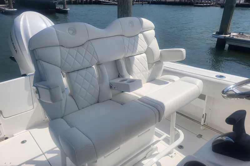 Slide: The Image of Luxurious seating on 2022 Edgewater 245CC boat, featuring white quilted upholstery. - 38